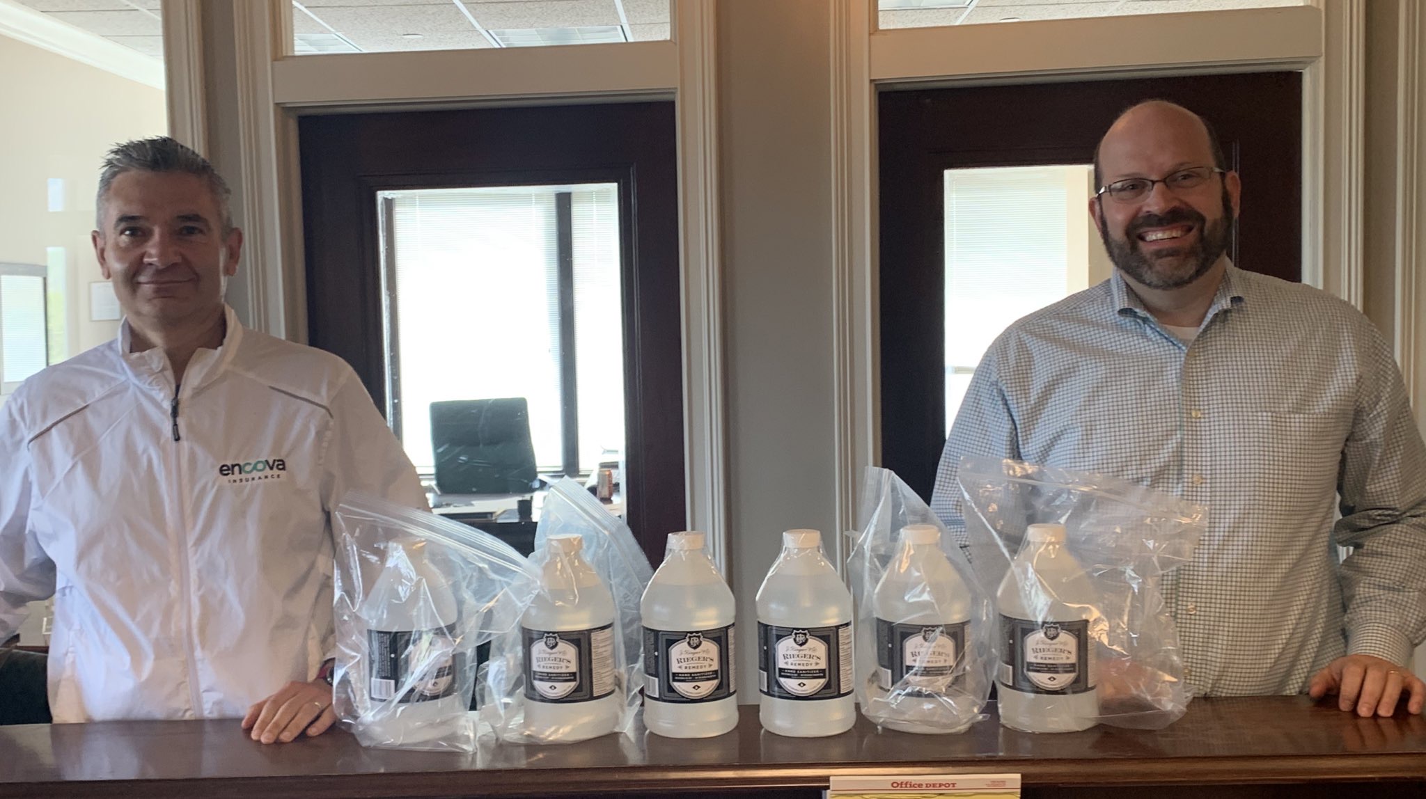 (Left to right) Toney Stroud, an attorney with Encova Insurance and Chair of the Huntington Regional Chamber, joins with Nick Preservati of Spilman Thomas & Battle law firm to deliver jugs of liquid hand sanitizer to area restaurants. 