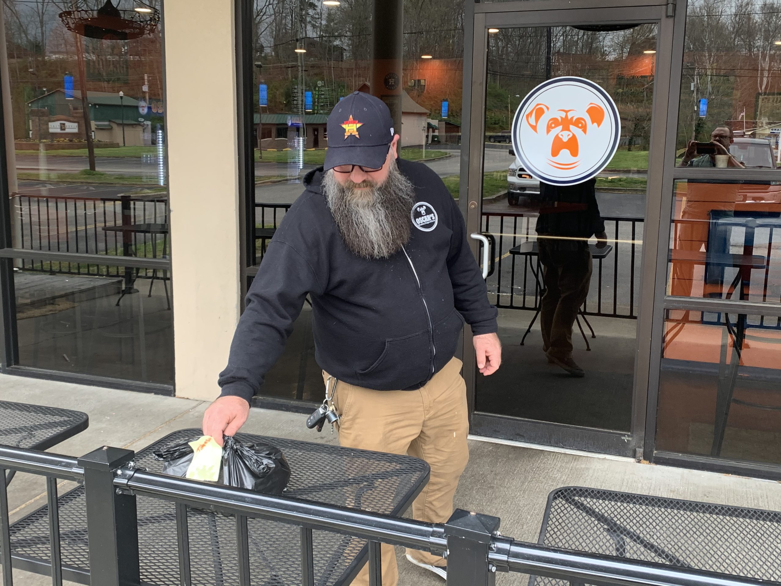 Jason Beter, owner of Oscar’s Breakfast, Burgers & Brews, places a curbside pickup order outside for a customer. Oscar’s has been one of the many Cabell County restaurants that developed curbside and delivery orders to meet the needs of their customers while protecting the health of their employees and customers.